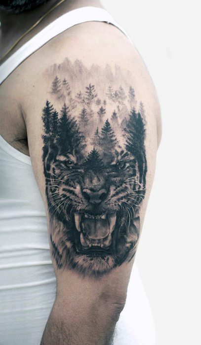 Black and grey tattoo of a roaring tiger with a forest of pine trees seamlessly blended into its face, symbolizing power and nature.