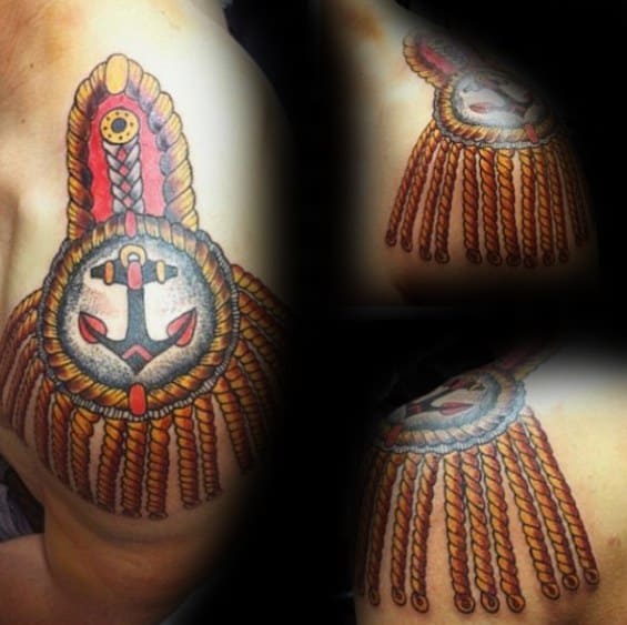 Vibrant epaulette tattoo with a red and black anchor centerpiece, braided gold ropes, and decorative tassels over the shoulder.