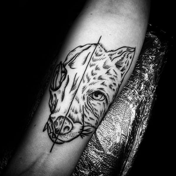 Blackwork forearm tattoo of a fox face split down the middle, with one side as a skull and the other as a living fox, featuring bold linework.
