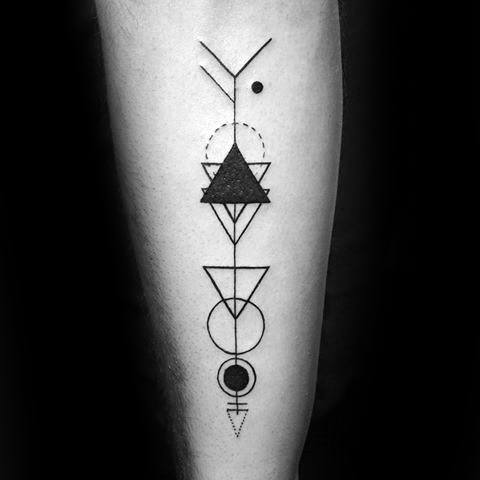 Abstract geometric arrow tattoo with stacked triangles, circles, and symbolic elements in a bold, symmetrical forearm design.