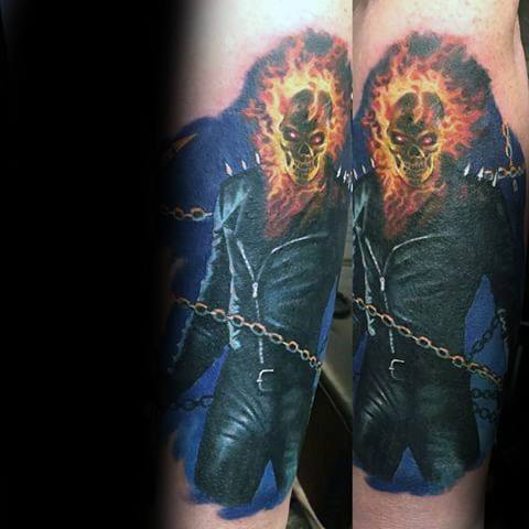 Ghost Rider tattoo with a full-body fiery skull figure in a black leather suit, glowing eyes, and a chain wrapped across the torso.