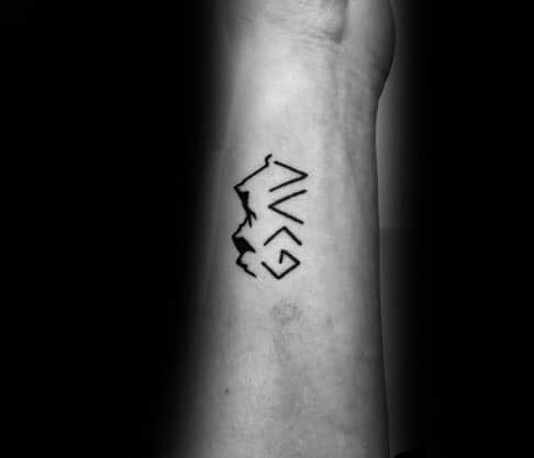 Minimalist wrist tattoo featuring "God is greater than the highs and lows" symbol integrated with a mountain outline design