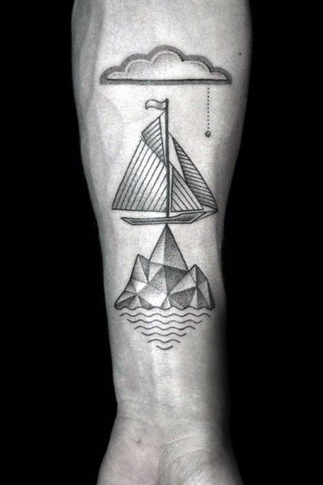 Minimalist forearm tattoo with a sailboat floating above a geometric iceberg, a stylized cloud, and dotted shading details.