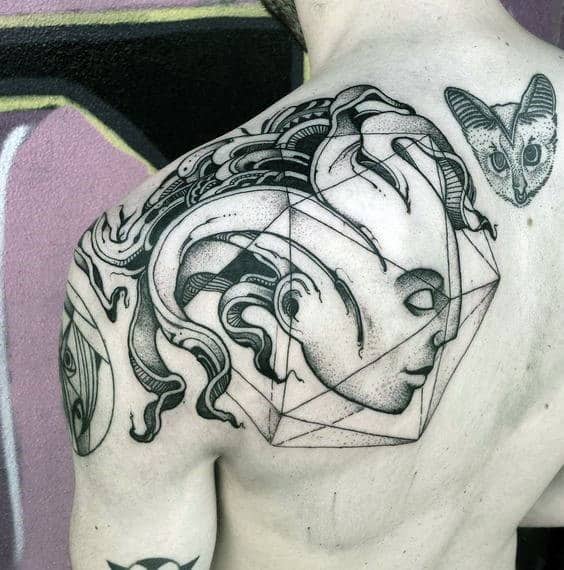 Surreal shoulder tattoo featuring a serene face and flowing elements encased in an icosahedron, blending abstract art with geometric form.
