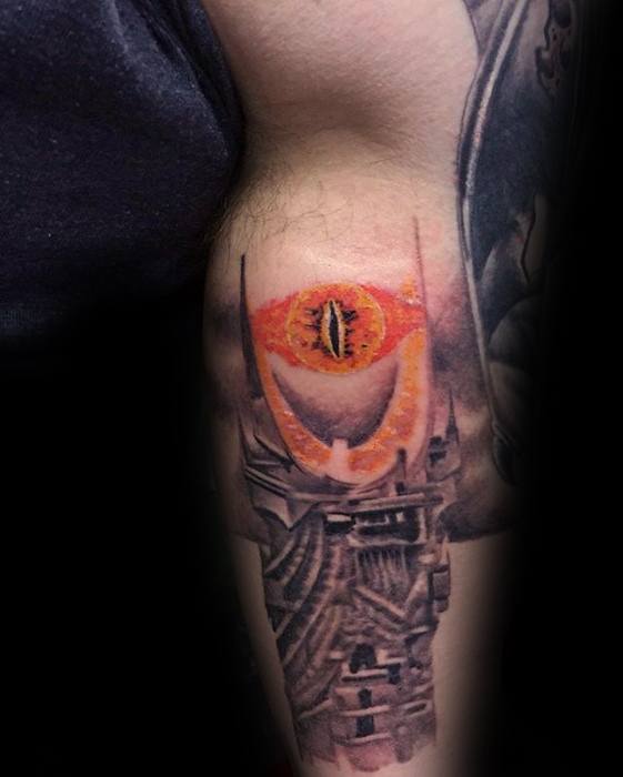 Tattoo of the Eye of Sauron with an orange iris and a dark tower beneath it 