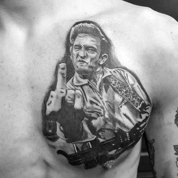 Black and white tattoo of Johnny Cash holding a guitar and making a rude gesture