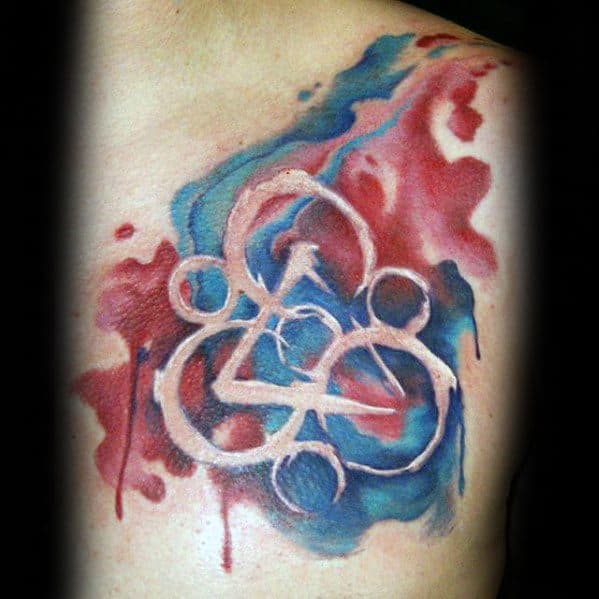 Coheed and Cambria Keywork tattoo on the chest with a soft, painterly effect, blending red and blue watercolor for a vibrant, dynamic look.