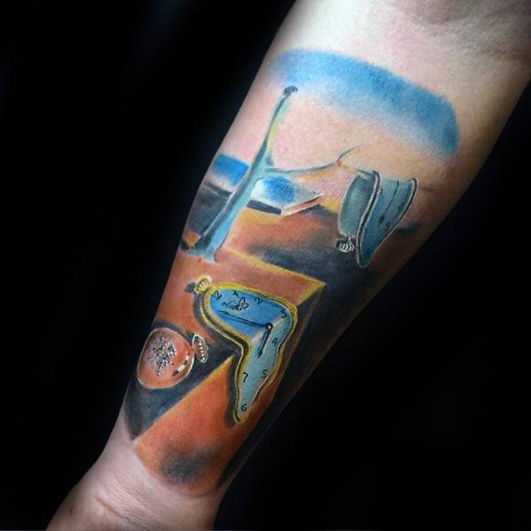 Colorful forearm tattoo inspired by Salvador Dali’s “The Persistence of Memory,” featuring melting clocks over a surreal desert landscape.