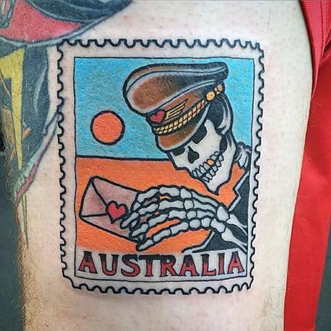 A tattoo depicting a skeleton in a postman's cap clutching an envelope, artfully designed as an Australia postage stamp