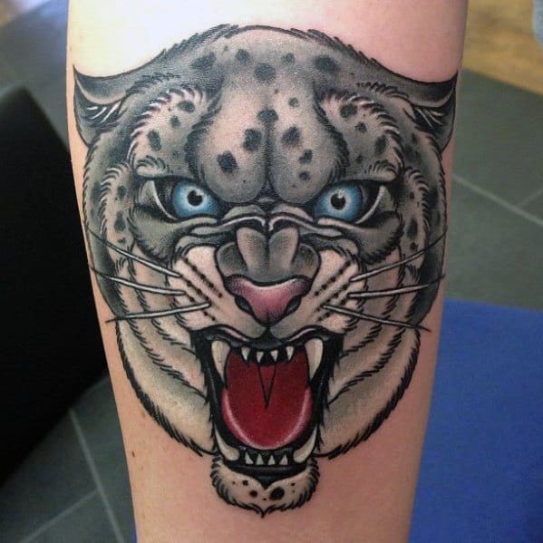 Neo-traditional snow leopard tattoo with intense blue eyes, open mouth, and bold outlines, combining fierce expression with clean detail.