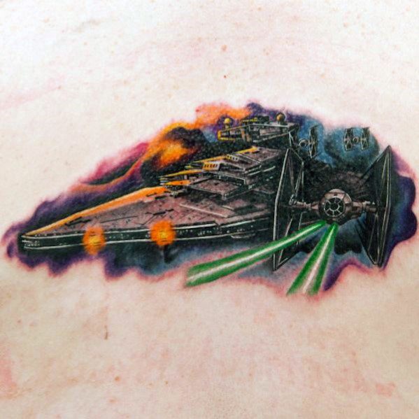 Color Star Destroyer tattoo with vibrant space backdrop, featuring TIE fighters firing green lasers in an action-packed battle scene.
