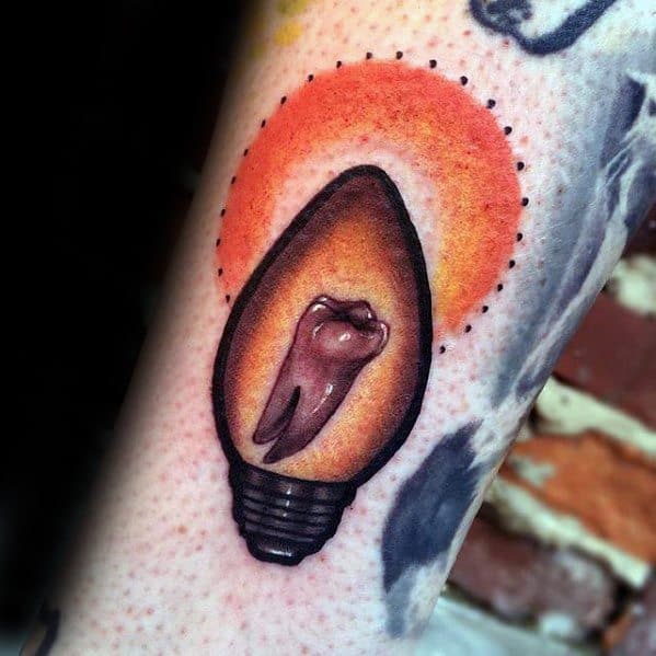 Creative Stranger Things tattoo of a glowing Christmas light bulb with a tooth inside, referencing Dustin’s missing teeth and the series’ spooky vibe.