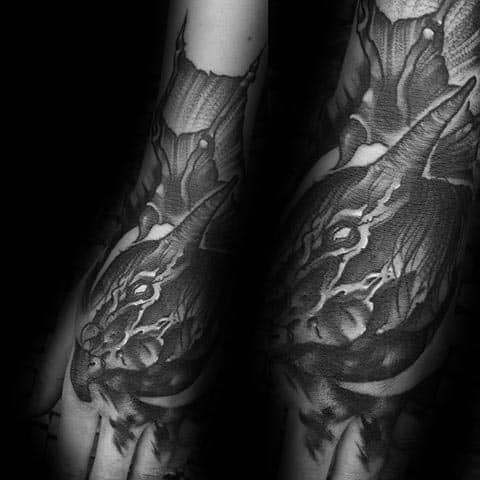 Intricate Thestral head tattoo with sharp textures and fine dotwork shading, covering the hand and wrist in a dark, mystical style.