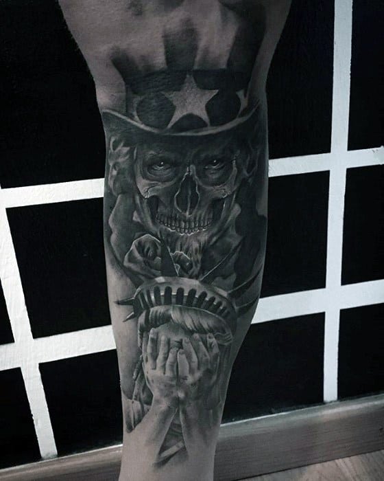 Dark and haunting Uncle Sam skull tattoo with the Statue of Liberty covering her face in despair, symbolizing a powerful and emotional message.