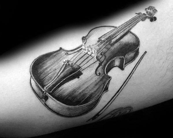 Realistic black and gray tattoo of a violin and bow on the arm, featuring fine shading and detailed wood texture for a lifelike appearance.