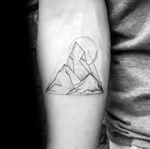 Minimalist geometric mountain tattoo on the forearm, featuring fine line peaks, abstract shading, and a dotted sun or moon for a modern artistic design.