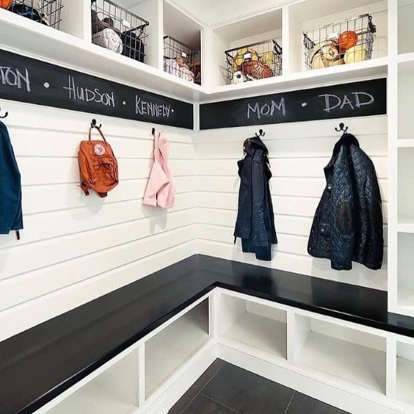 mudroom with coat hooks and corner bench seating