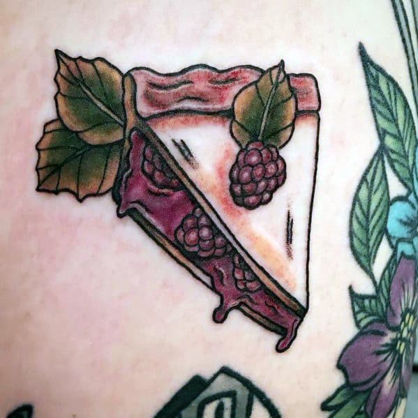 Raspberry pie slice tattoo with dripping filling, detailed leaves, and berries, blending a vintage-inspired look with a classic dessert theme