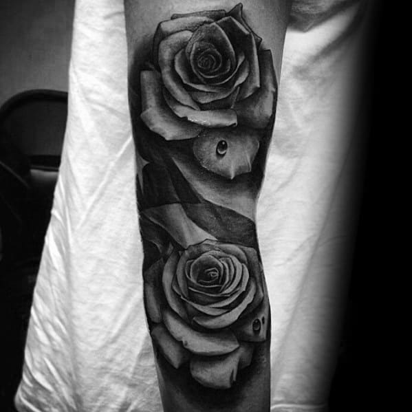 Black and grey Puerto Rican flag tattoo intertwined with realistic roses and water droplets, symbolizing beauty, pride, and resilience.