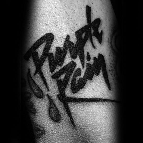 Close-up of "Purple Rain" tattooed in stylized black script with droplets, a nod to Prince's iconic legacy
