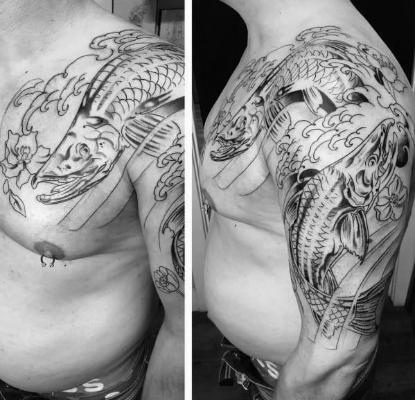 Black and grey Japanese-style tattoo of a leaping salmon with dynamic waves and floral elements, covering the shoulder and chest in a bold design.