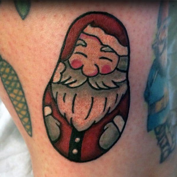 Cute and minimalist Santa Claus tattoo with a matryoshka doll-inspired design, featuring bold outlines, soft shading, and a cheerful expression.