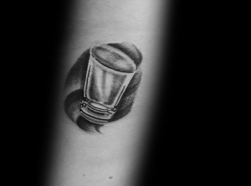 Realistic black and grey shot glass tattoo with fine shading and a swirling background, creating a bold and dynamic 3D effect.