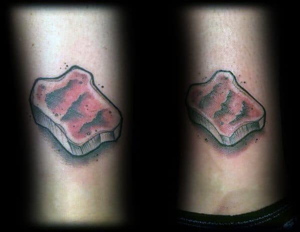 Realistic toast tattoo with a jam spread effect, featuring soft shading and a three-dimensional look for a simple yet appetizing design.