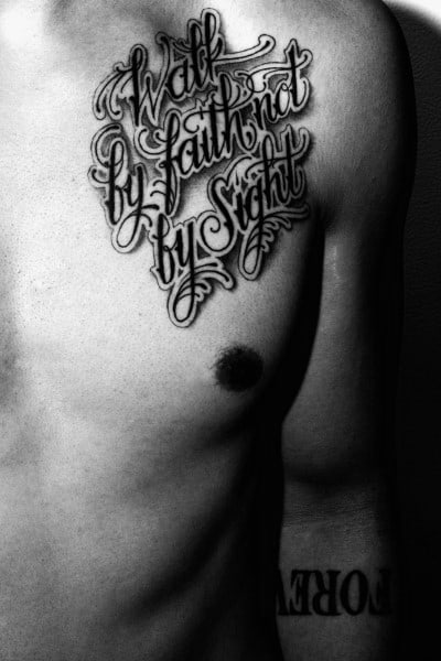 Chest tattoo featuring "Walk by Faith, Not by Sight" in bold, decorative script with intricate flourishes, creating a powerful and inspiring design.
