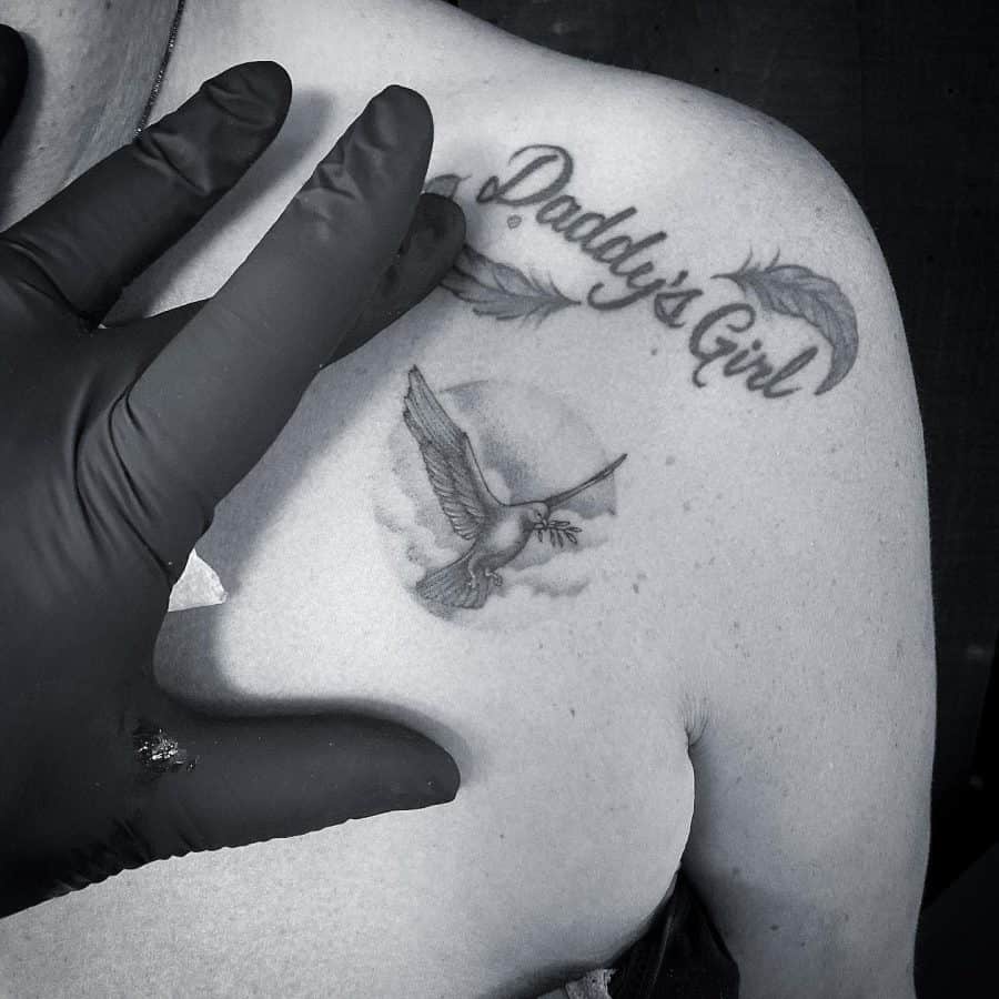 Tattoo of "Daddy's Girl" with feathers and a bird