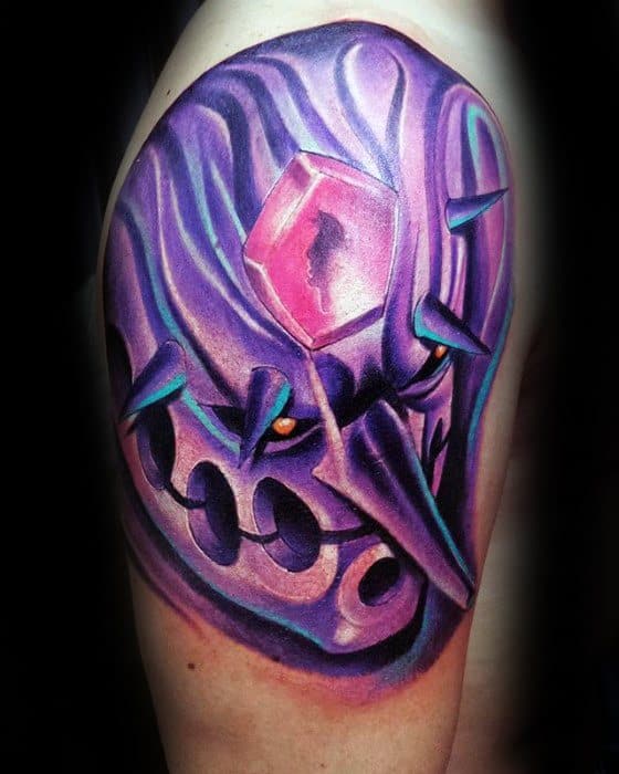 Vivid tattoo of a Susanoo with glowing orange eyes, sharp spikes, and a prominent pink gem.