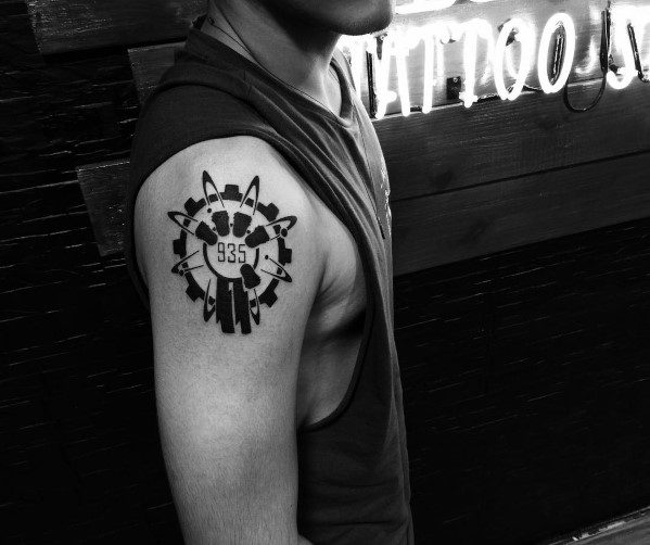 Bold black Call of Duty Group 935 tattoo on the upper arm, featuring a circular design with bullets and the iconic zombie division emblem.
