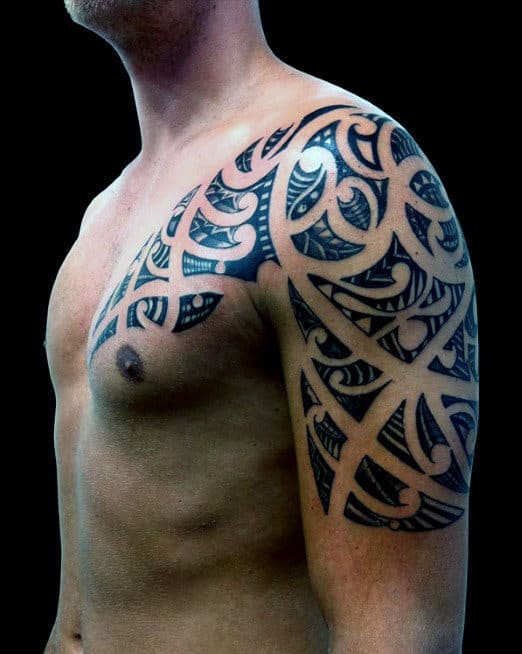 Upper Arm And Shoulder Maori Tattoo On Man