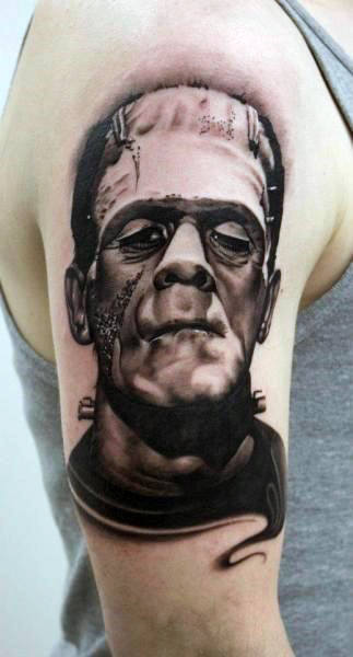 Upper Arm Black Ink Shaded Male With Tattoo Of Frankenstein