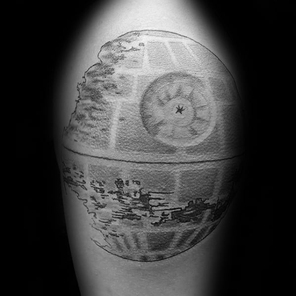 Black and gray tattoo of a partially constructed Death Star on skin
