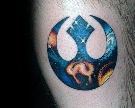 Rebel Alliance tattoo on the upper arm with a vibrant galaxy design, including stars and nebulae
