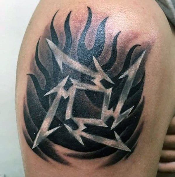 Metallica ninja star logo tattoo on the shoulder, featuring sharp silver edges over a bold black flame background for a fiery effect.