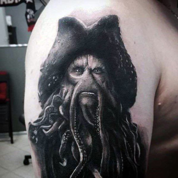 Tattoo of Davy Jones with a tentacled face on an upper arm