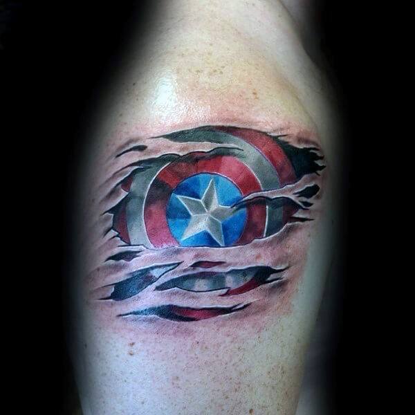 3D-style tattoo of Captain America's shield appearing beneath torn skin, with vibrant red, white, and blue colors and realistic ripped flesh effect.