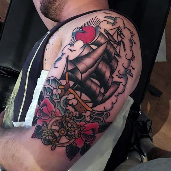 Upper Arm Sailing Ship With Ship Wheel And Rose Flowers Tattoo For Males