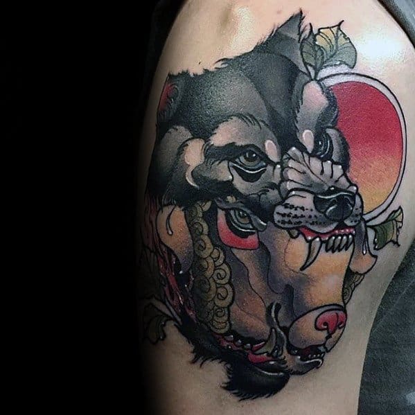 Tattoo of a wolf and sheep combined on the upper arm, detailed with a red circle in the background.