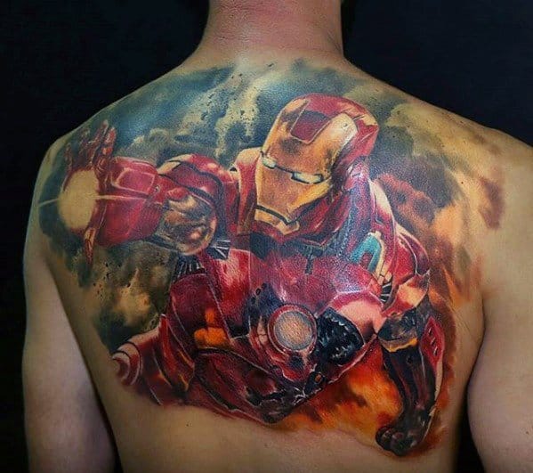 Iron Man tattoo spanning the back, featuring a dynamic action pose with him blasting a repulsor beam, surrounded by fiery, dramatic colors that capture movement and intensity.