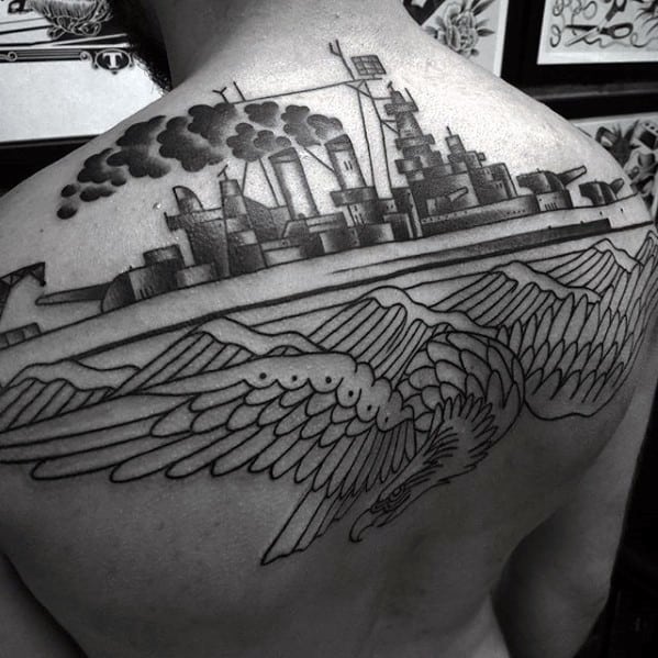 Black and gray tattoo of a battleship and eagle on a person's back