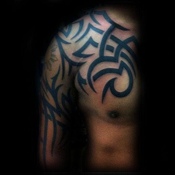 Upper Chest And Arm Male Traditional Tribal Tattoo Inspiration