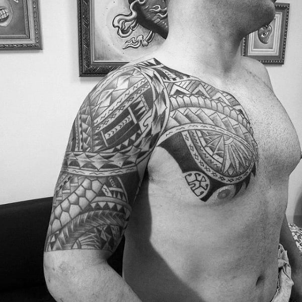 Upper Chest And Half Sleeve Tribal Tattoo On Guy