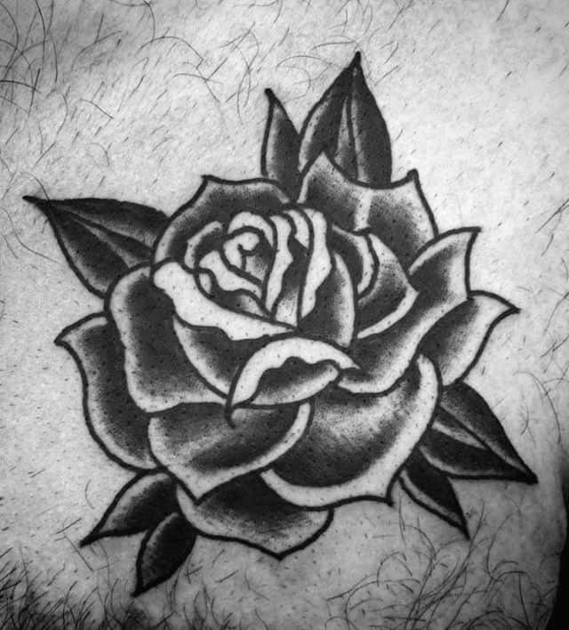 Black and white tattoo of a rose with detailed shading and leaves