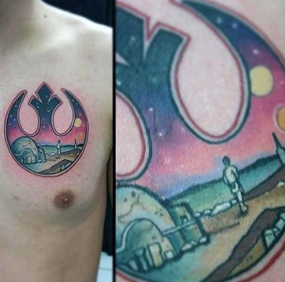 Close-up of a chest tattoo with a Star Wars Rebel Alliance logo and a Tatooine landscape scene