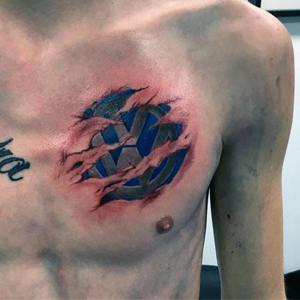 Volkswagen logo chest tattoo with a torn skin effect, revealing a metallic blue emblem underneath for a bold 3D illusion.