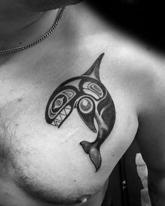 Tribal-inspired orca tattoo on the chest, featuring bold black lines and intricate patterns, forming a dynamic and symbolic representation of the whale.