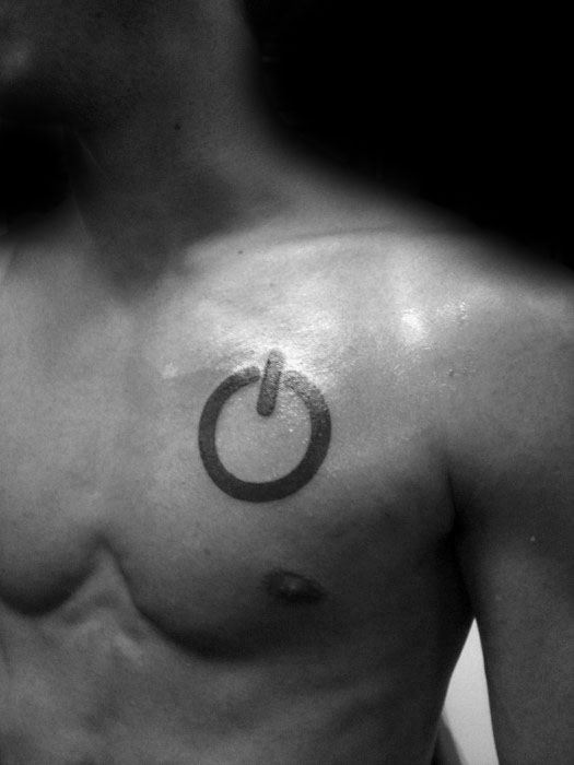Bold power symbol tattoo on the upper chest, designed with clean lines and a slightly shaded circular form.